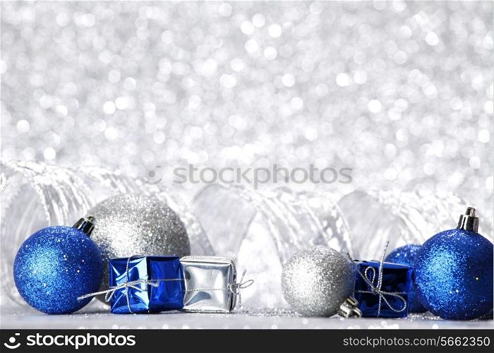 Decorative Christmas ball and gift on abstract glitter silver background