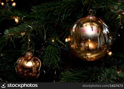 Decorative Christmas balls hanging on pine - tree branch
