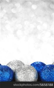 Decorative Christmas balls on abstract glitter silver background