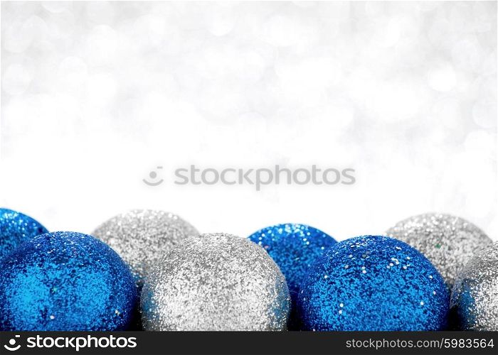 Decorative Christmas balls on abstract glitter silver background