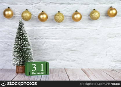 Decorative Christmas tree and green wooden perpetual calendar with date on white brick wall background. Banner, header, New Year background with copy space