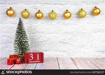 Decorative Christmas tree, gift boxes and red wooden perpetual calendar with date 31 december on white brick background with festive garland. Banner, header, New Year background with copy space