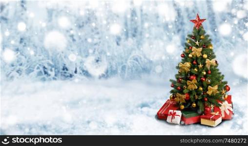 Decorative Christmas Tree over winter snowy forest background wit copy space. Christmas Tree in winter