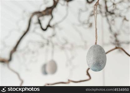 Decorative easter eggs hanging from a twig at easter