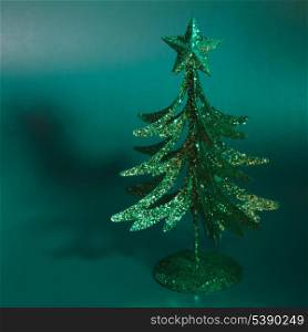 Decorative fir tree over green background