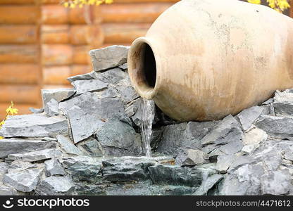 Decorative garden waterfall made with stone jar