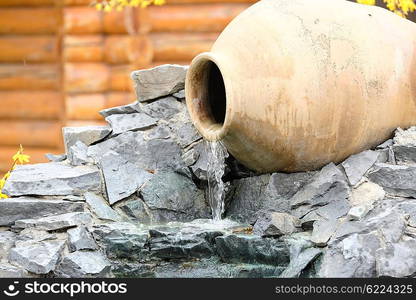 Decorative garden waterfall made with stone jar