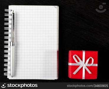 decorative gift box with notepad on dark table