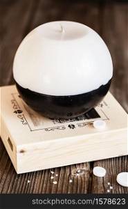 Decorative Handmade sphere and cylinder shape candles. Big black and white gift candles on the grey background