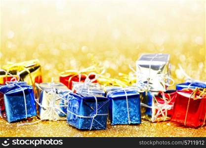 Decorative holiday colorful gift boxes on bright shiny background