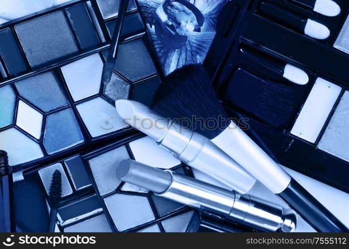 decorative make up cosmetics with powder and brusheson eye shadows in classic blue color. Decorative cosmetics
