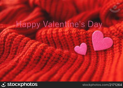 Decorative pink heart on a red knitted background, top view. Ready card, inscription Happy Valentine&rsquo;s Day. Decorative pink heart on a red knitted background, top view. Ready card, inscription Happy Valentine&rsquo;s Day.