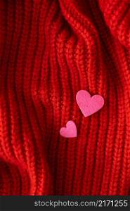 Decorative pink heart on a red knitted background, top view. Place for an inscription. Decorative pink heart on a red knitted background, top view. Place for an inscription.