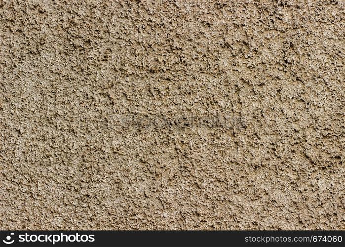 Decorative plaster with small stones shades of light brown as background or texture. Texture of stucco.