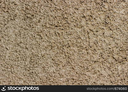 Decorative plaster with small stones shades of light brown as background or texture. Texture of stucco.