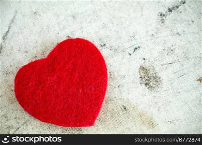 Decorative red heart on dirty background with copy-space