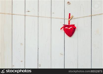 Decorative red hearts hanging on vintage wooden background with space. Valentine background.