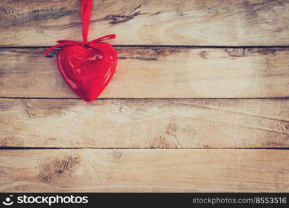 Decorative red hearts hanging on vintage wooden with space. Valentine background.