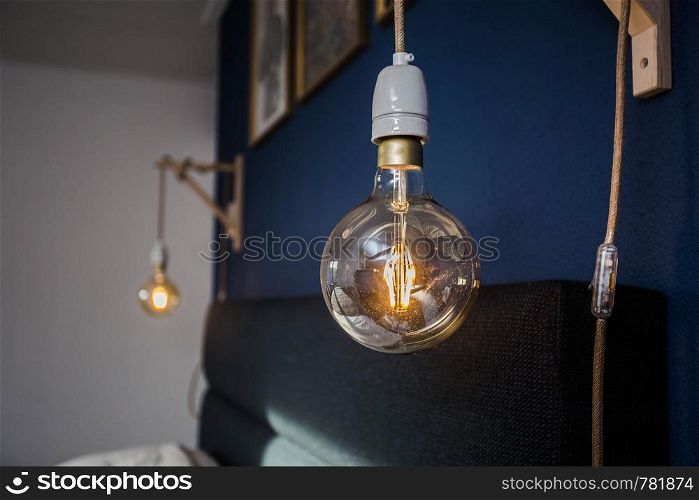 Decorative retro light bulbs against blue wall background, modern design vintage. Decorative retro light bulbs against blue wall background, modern design