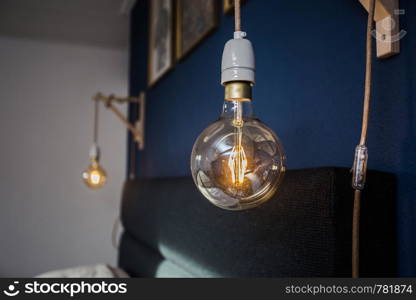 Decorative retro light bulbs against blue wall background, modern design vintage. Decorative retro light bulbs against blue wall background, modern design