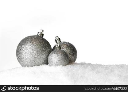 Decorative shiny Christmas balls on snow