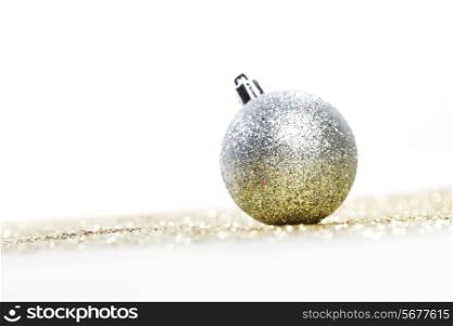 Decorative silver christmas ball on golden background