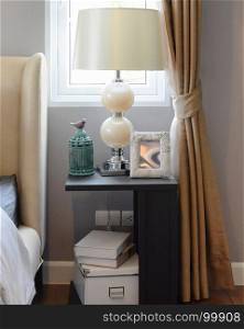 decorative table lamp on black wooden table in bedroom interior
