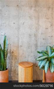 Decorative table with flower arrangement with concrete wall as background