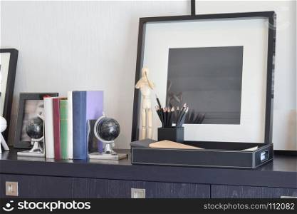 decorative tray with book and pencils on wooden table at home