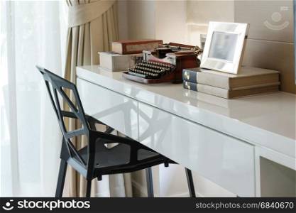 decorative working table with typewriter and books