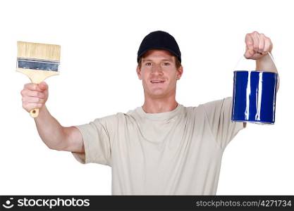 Decorator holding paint tin and brush