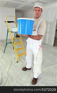 Decorator with a large pot of paint