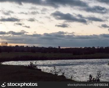 dedham night time river stour scene landscape church in background silhouette; essex; england; uk