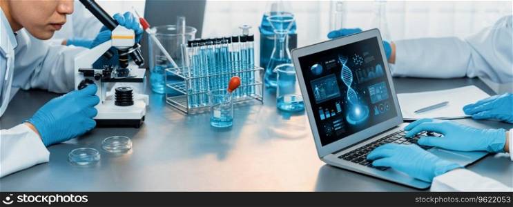 Dedicated scientist group working on advance biotechnology computer software to study or analyze DNA data after making scientific breakthrough from chemical experiment on medical laboratory. Neoteric. Scientist working on biotechnology computer software to study DNA. Neoteric