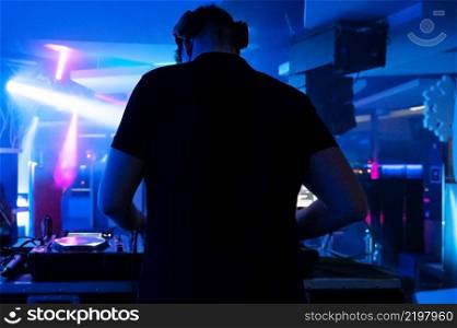 Deejay mixing at party. High quality photography.. Deejay mixing at party