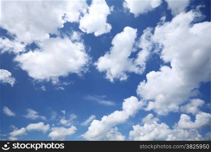 Deep blue sky background with white clouds