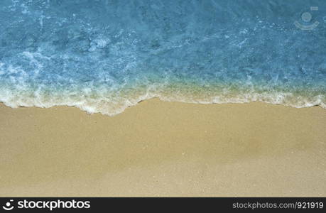 Deep blue water, waves and sandy beach. Beautiful coastline with copy space. Top view.