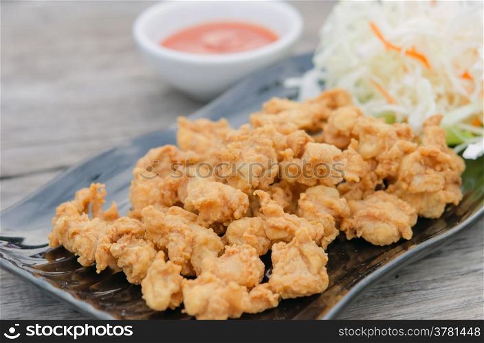 deep fried chicken tendons with fresh vegetable and chili sauce, asian style cuisine