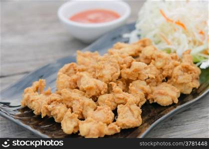 deep fried chicken tendons with fresh vegetable and chili sauce, asian style cuisine