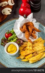 Deep fried chicken with french fries and salad