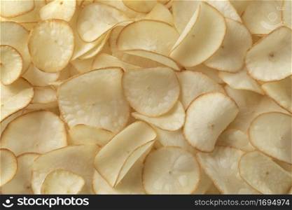 Deep fried crunchy cassava chips close up full frame as background