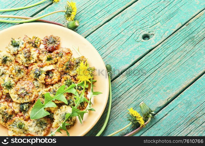 Deep fried dandelion flower on old wooden table. Fried dandelion flowers