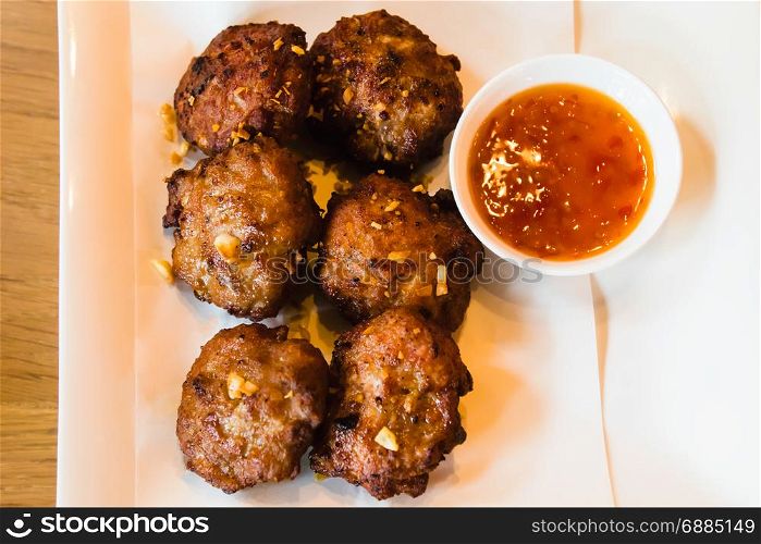 Deep fried pork meatballs with spicy sauce