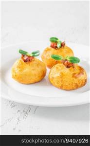 Deep fried potato parmesan balls with glazed bacon