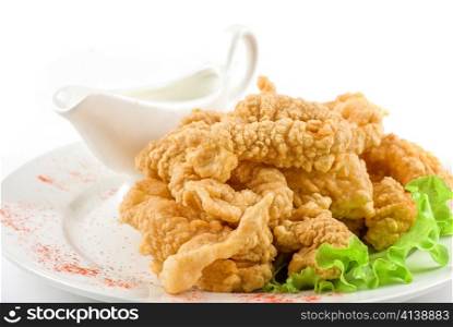 Deep-fried squid with salad leaves, sauce, on a white background