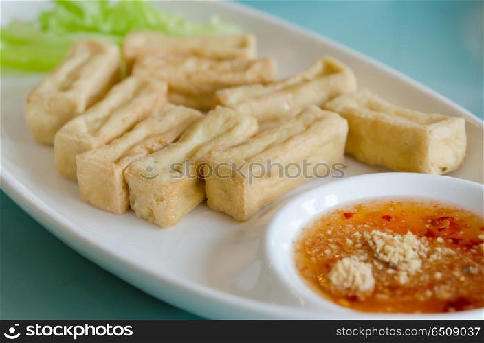 deep fried tofu served with fresh lettuce and spicy sauce