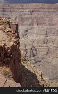 Deep slope drops vertically down into Grand Canyon