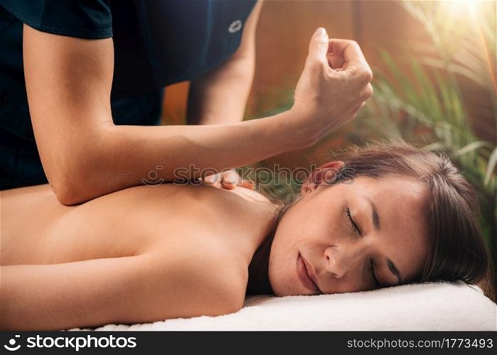 Deep Tissue Massage Therapy. Therapist massaging Woman&rsquo;s Back, using Elbow Pressure.. Deep Tissue Massage Close up.