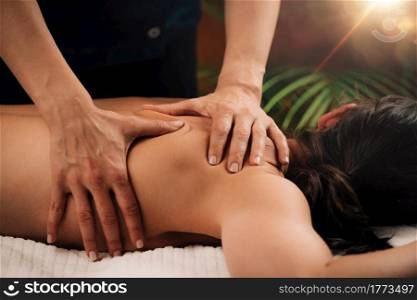 Deep tissue massaging therapy. Therapist hands massaging woman&rsquo;s shoulder. Deep Tissue Massaging.