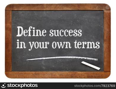 Define success in your own terms - inspirational words on a vintage slate blackboard